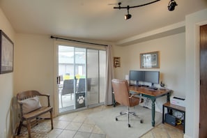 A room with a desk, chair, computer, and a sliding glass door leading to an outdoor area. - 0651: Central Salida Home 5 Blocks to Dtwn & River (Salida)