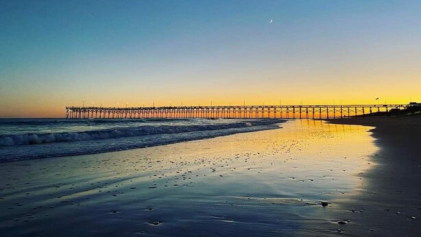 A pier extending into calm waters at sunset. - Surf City • Views, Views, and more Views! (Surf City)