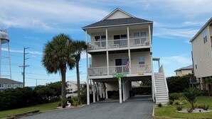 A two-story building with a balcony on the upper floor. - Surf City • Views, Views, and more Views! (Surf City)