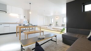 A modern living space with a kitchen, dining area, and seating area. - b hotel 902 Central Inner-Side Comfort Studio (Hiroshima City)