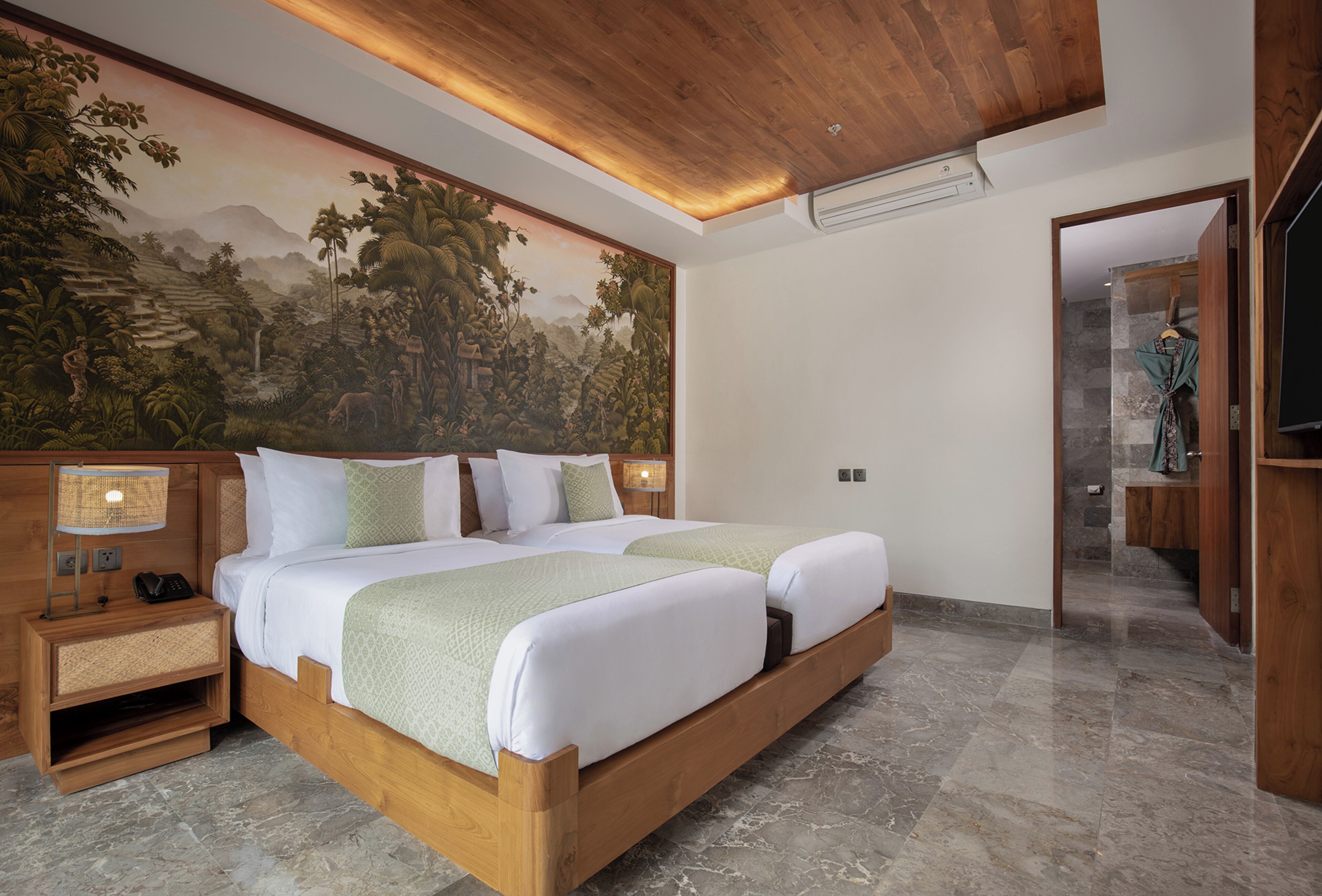 A bedroom with a large mural, a wooden bed frame, and a nightstand with a lamp.