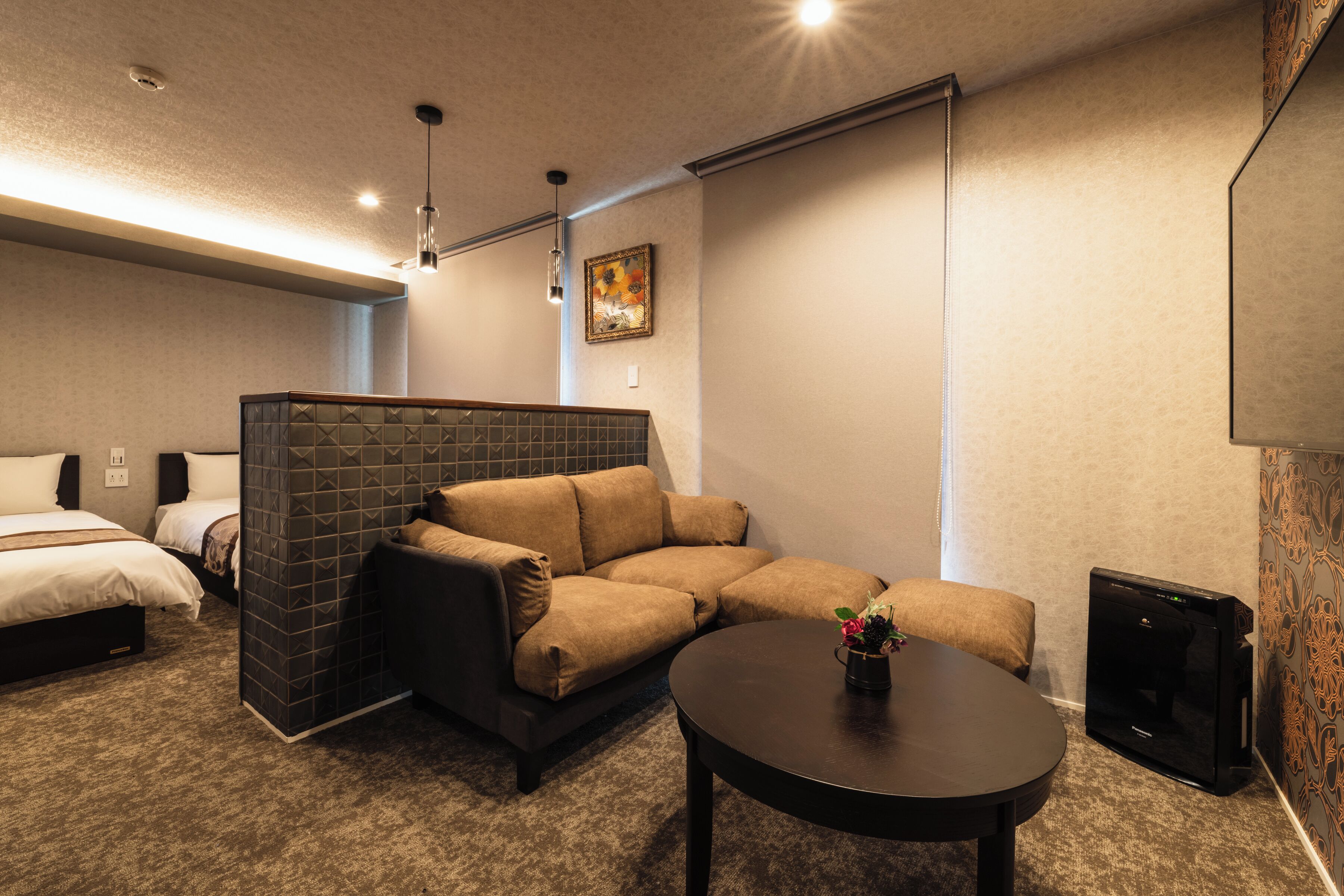 A cozy room with a sectional sofa, a small table, and a TV.
