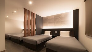 A modern hotel room with three beds, a large window, and a wooden partition. - GRAND BASE Hakata Premium (Fukuoka)