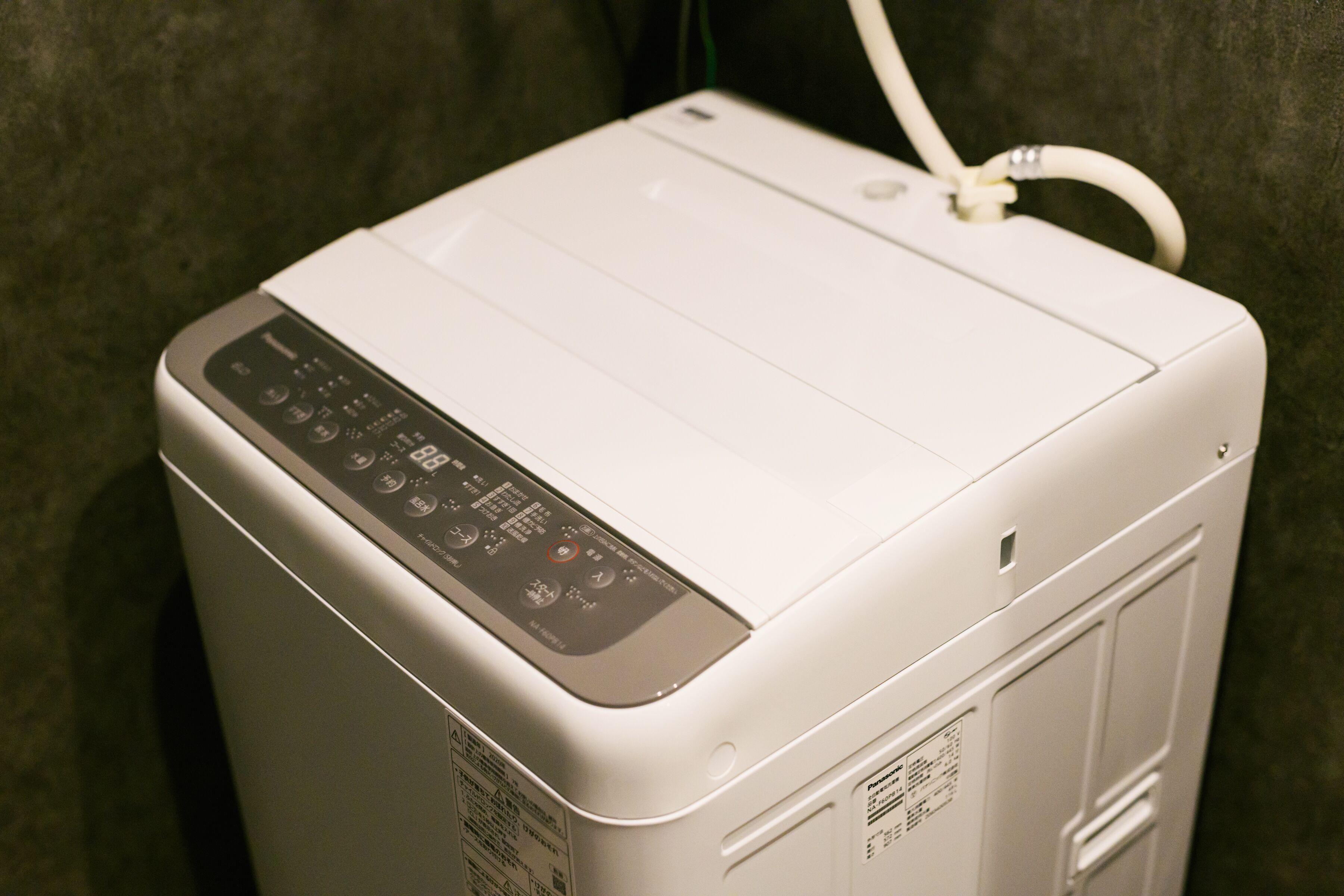 A white portable heater with a control panel and a power cord.
