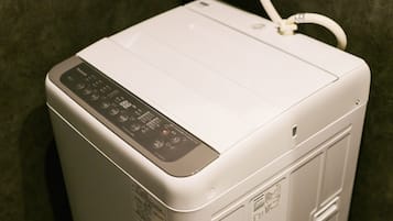 A white portable heater with a control panel and a power cord.
