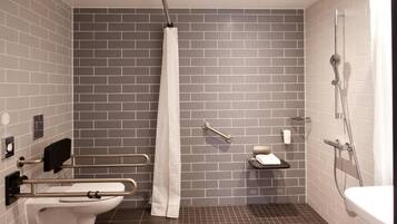 Ein modernes Badezimmer mit Toilette, Dusche und Haltegriffen.
