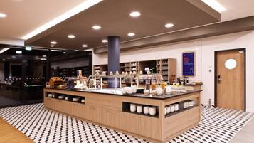 A modern kitchen area with a central island, wooden cabinets, and a tiled floor.