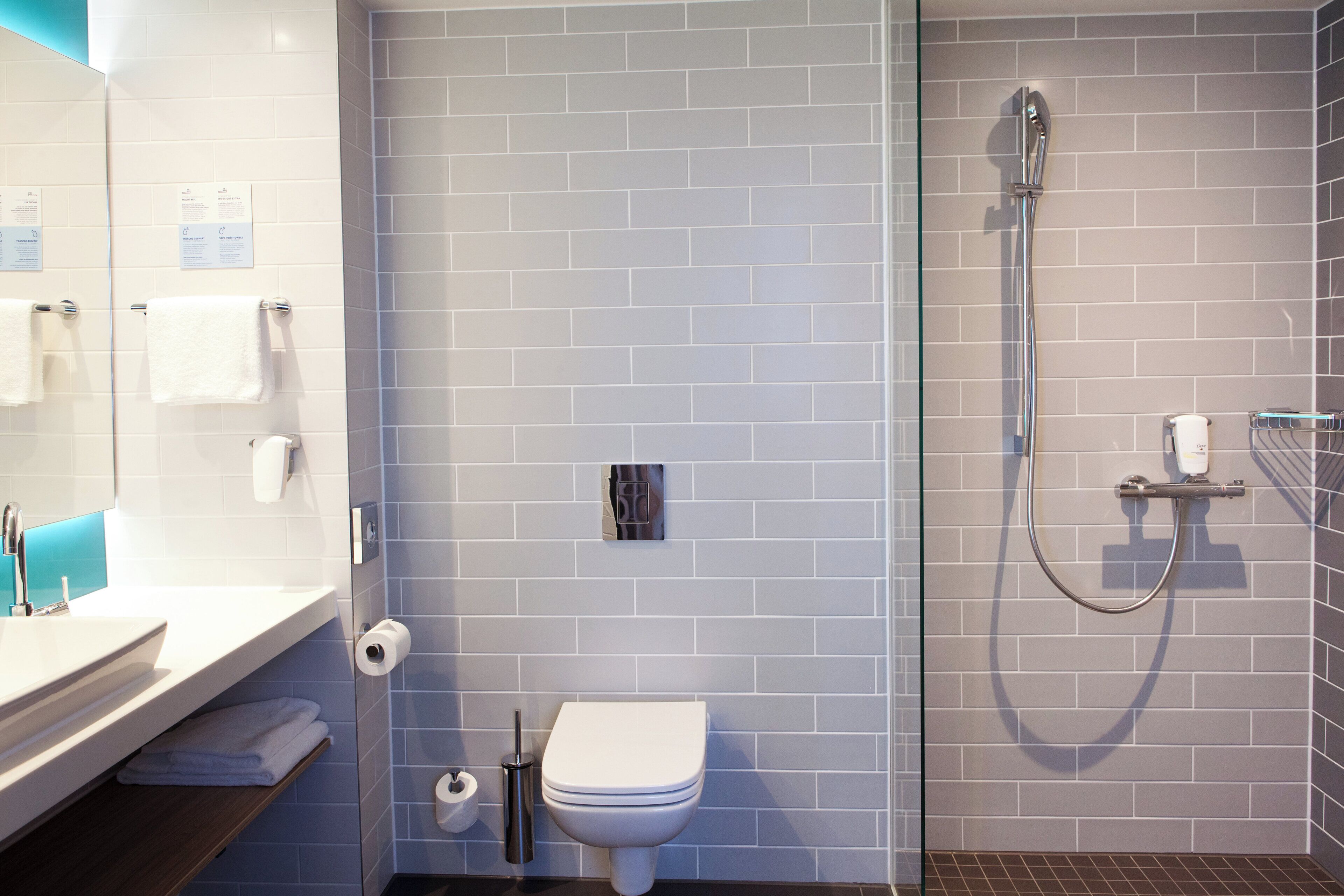 A modern bathroom with a toilet, bidet, and shower.