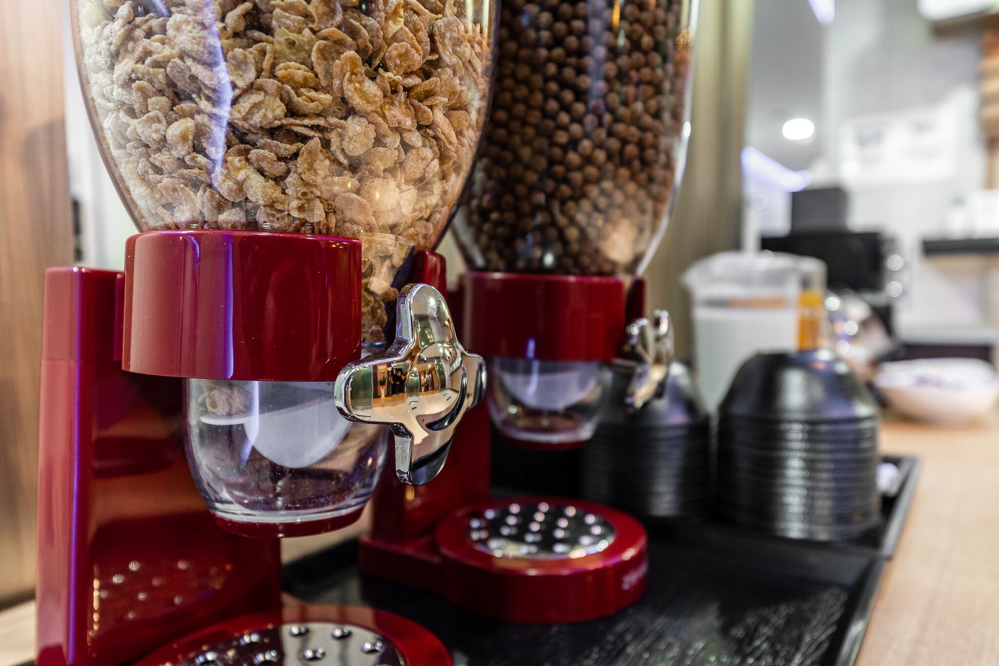 A coffee machine with multiple dispensers, including one for coffee beans and another for ground coffee.