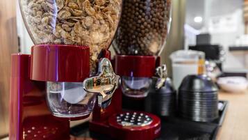 A coffee machine with multiple dispensers, including one for coffee beans and another for ground coffee.
