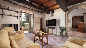 A cozy living room with a fireplace, a television, and comfortable seating. - Villa Di Morice 14, Emma Villas (Castel Ritaldi)