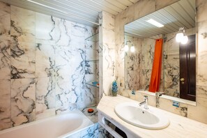 Bathtub, hair dryer, soap, shampoo