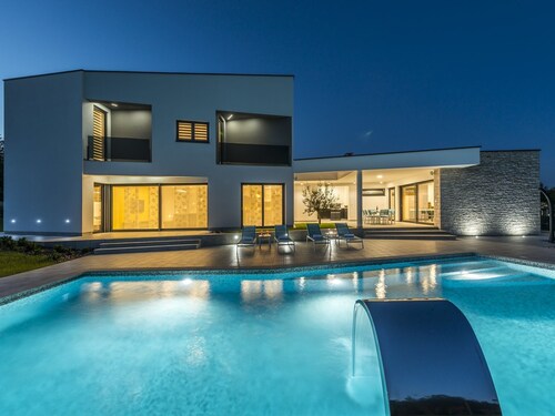 A Modern Luxury Villa With a Crystal-clear Swimming Pool and Cultivated Garden