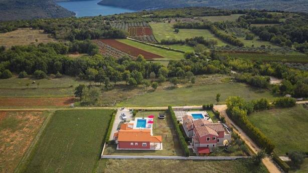 An aerial view of a property with a swimming pool, two houses, and surrounding fields. - Detached Villa With Pool and Large Garden in Quiet Area Near the Sea (Barban)