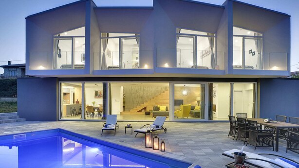 A modern two-story house with a swimming pool, outdoor seating, and large glass doors leading to the interior. - Villa in Liznjan With Pool Near the Beach (Liznjan)