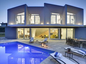A modern two-story house with a swimming pool, outdoor seating, and large glass doors leading to the interior. - Villa in Liznjan With Pool Near the Beach (Liznjan)