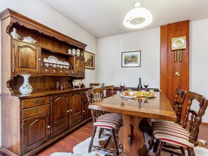 A dining room with a wooden table, chairs, and a cabinet with dishes. - Holiday Home in Pula Near Crystal Clear Sea (Pula)