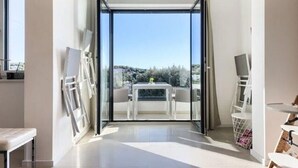 A modern room with a large sliding glass door leading to an outdoor terrace. - Villa in Pula With Private Swimming Pool (Medulin)