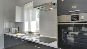 A modern kitchen with a built-in oven, microwave, and stainless steel appliances. - Modern Holiday Home With Pool in Pazin (Pazin)