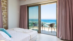 A bedroom with a large sliding glass door leading to a balcony with a view of the sea. - Scenic Villa With Private Pool (Kissamos)