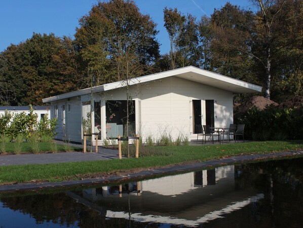 A small, single-story building with a flat roof and a covered patio area.