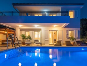 A modern two-story house with a swimming pool, outdoor seating, and a covered patio area. - Villa in Cres With Sea Views & Pool (Cres)