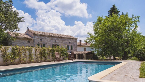 A swimming pool with a stone building in the background. - Spacious Holiday Home in Svetvincenat With Pool (Svetvincenat)