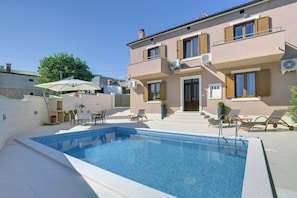 A residential building with a swimming pool, outdoor seating, and a balcony. - Holiday Home in Liznjan Near the Beach (Liznjan)