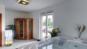 A modern bathroom with a hot tub, a wooden cabinet, and a window with a view of the outside. - Villa in Bratulici With Pool Near Beach (Marcana)