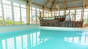 A large indoor swimming pool with a wooden ship decoration in the center. - Spacious Holiday Home on Markermeer near Amsterdam (Uitdam)