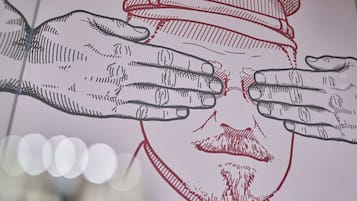 A drawing of hands covering a face.