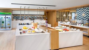 A modern breakfast bar with a variety of food items and a beverage dispenser. - Fairfield by Marriott Beijing Haidian (Beijing)