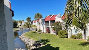 A residential area with houses, a small water feature, and well-maintained lawns. - Escape to Classic Anna Maria Island Charm (Bradenton Beach)