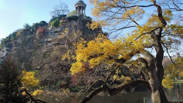 A park with a prominent rock formation and a gazebo on top.