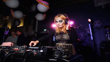 A DJ booth with Pioneer equipment, a microphone, and a Pioneer mixer.