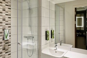 A modern bathroom with a glass-enclosed shower, a white sink, and a large mirror. - Premier Inn Darlington Town Centre Hotel (Darlington)