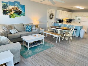 Relax in this inviting space with a sofa, dining table, and kitchen area.