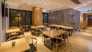 A modern restaurant with wooden tables and chairs, a glass partition, and a ceiling with recessed lighting. - Borrman Hotel (Guangzhou Tianhe Sports Center Linhe West Metro Station) (Guangzhou)