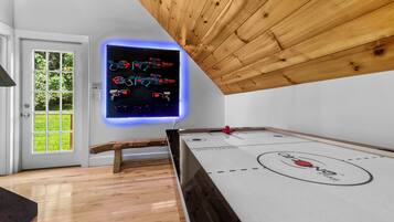 Enjoy a game of hockey in the room's dedicated space, featuring a hockey table and wall-mounted puck holder.