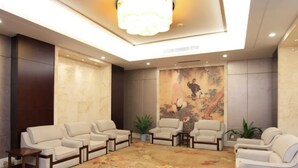 A spacious lobby with a high ceiling, a large mural, and multiple seating areas. - Haiyan International Hotel (Jiaxing)