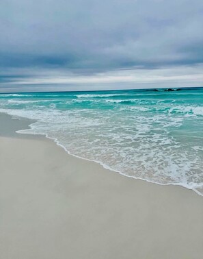 A beach with waves gently lapping onto the shore under a cloudy sky. - Beautiful, 30A Cabana Breeze @ Gulf Place, Santa Rosa Beach, FL, Gulfview (Santa Rosa Beach)