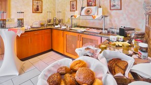 Montaje de un bufé de desayuno con diversos alimentos y bebidas.