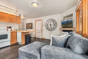 A modern kitchen with wooden cabinets, a built-in oven, and a dishwasher.