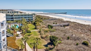 A beachfront hotel with a pool, beach access, and a pier.