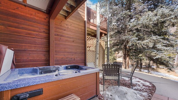 A wooden cabin with a hot tub, a bench, and a chair outside. - Fall River Hideaway • Private Hot Tub• Close to RMNP (Estes Park)
