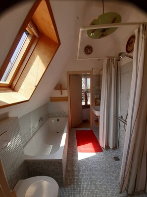 Bathtub, hair dryer, towels, soap