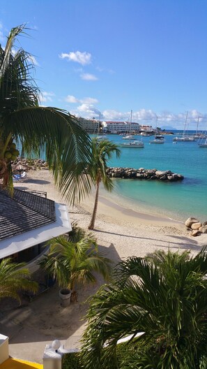 Enjoy a serene beachfront setting with a clear view of the sea and marina, perfect for relaxation and leisure activities.
