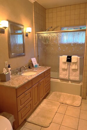 Combined shower/tub, hair dryer, towels, soap