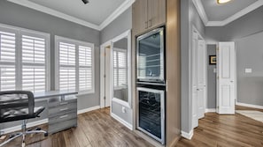 Enjoy a comfortable stay in this stylish room with a large window, oven, and cozy seating area.
