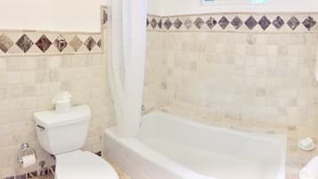 Bathtub, towels, soap, toilet paper